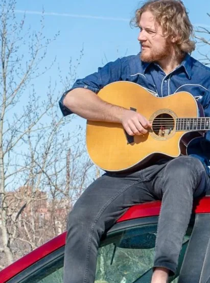 Travis Matthews playing guitar